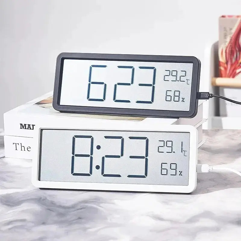 LCD digital clocks in white and black displaying time, temperature and humidity; desktop battery-powered.