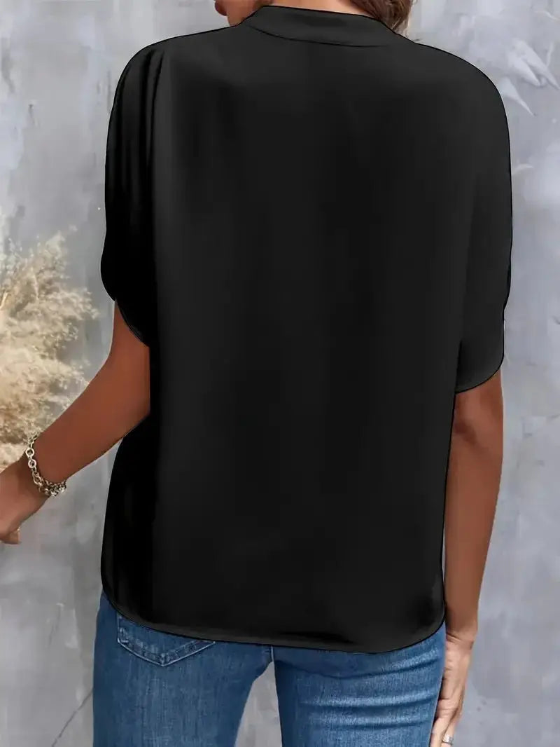 Women's black solid blouse, back view, short sleeves, loose fit