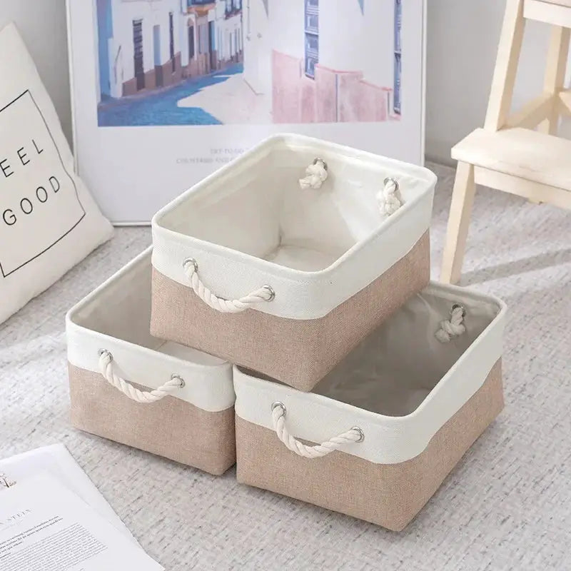 Three linen fabric storage baskets with white trim and rope handles, foldable, beige tone, large capacity.