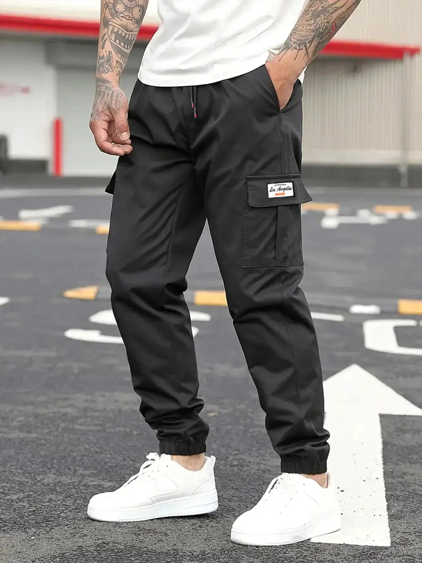 Men's black cargo jogger pants with drawstring waist and elastic cuffs; side cargo pocket.
