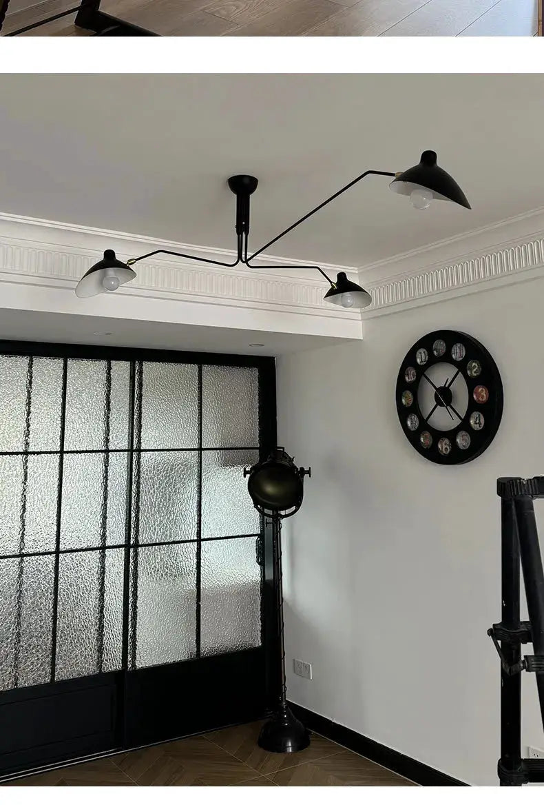 Simples Market spider pendant light with black metal arms and three white lampshades