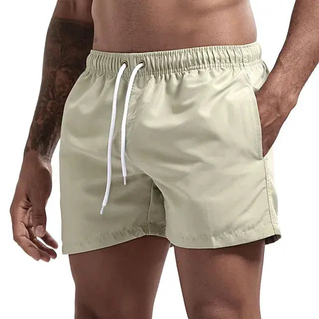 Simples Market men's beige swim trunks with white drawstring, quick-dry board shorts with pockets.