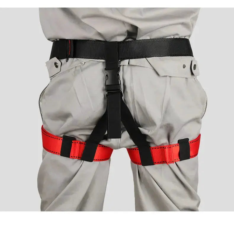 Outdoor rock climbing harness with black waist belt and red thigh straps by Simples Market