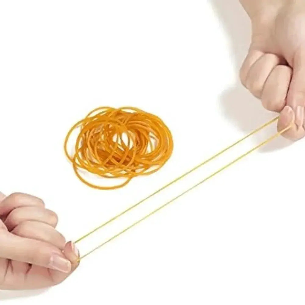 Simples Market yellow high-elastic rubber bands stretched between fingers with a bundle of bands in the background