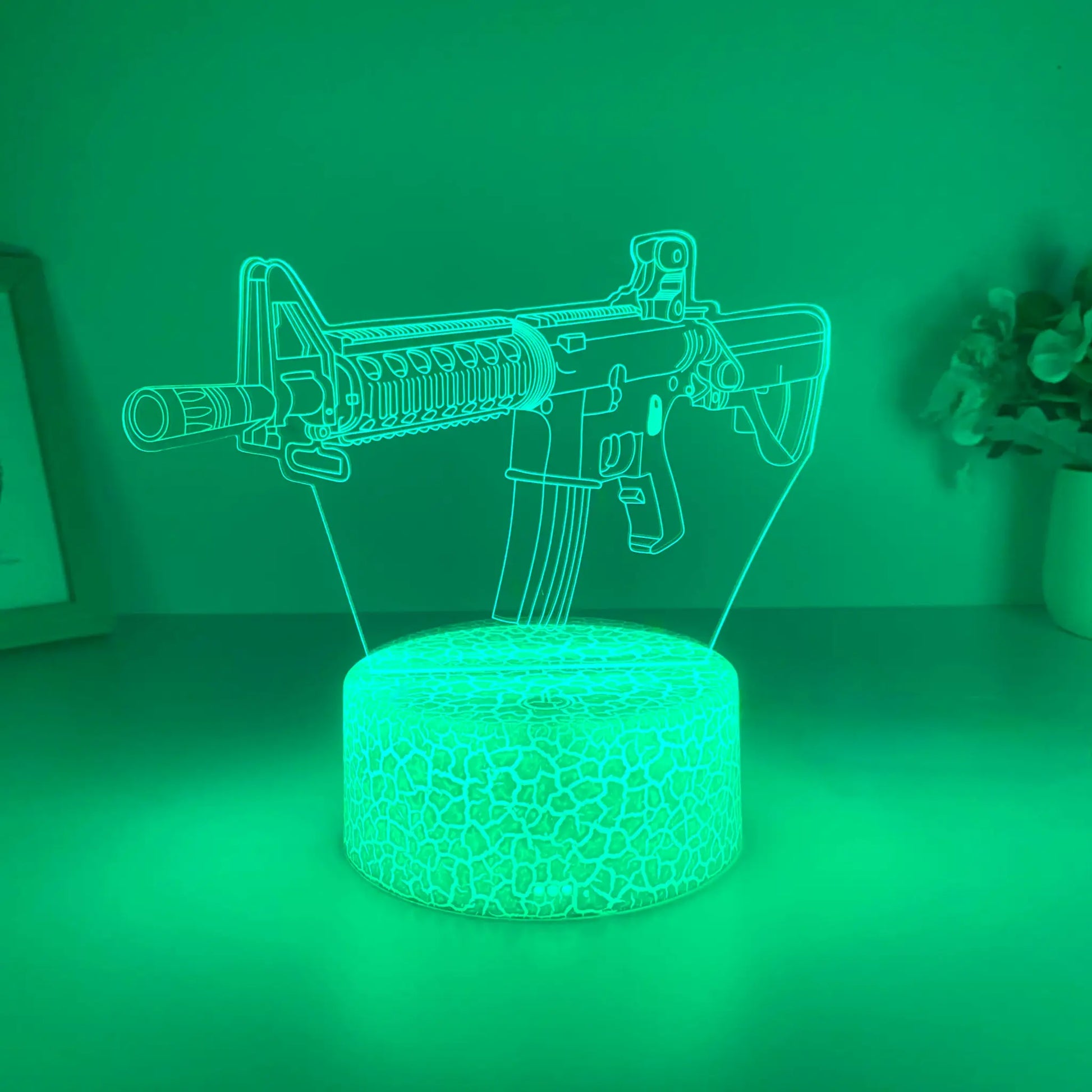 Simples Market submachine gun night light; green acrylic outline on glowing base.