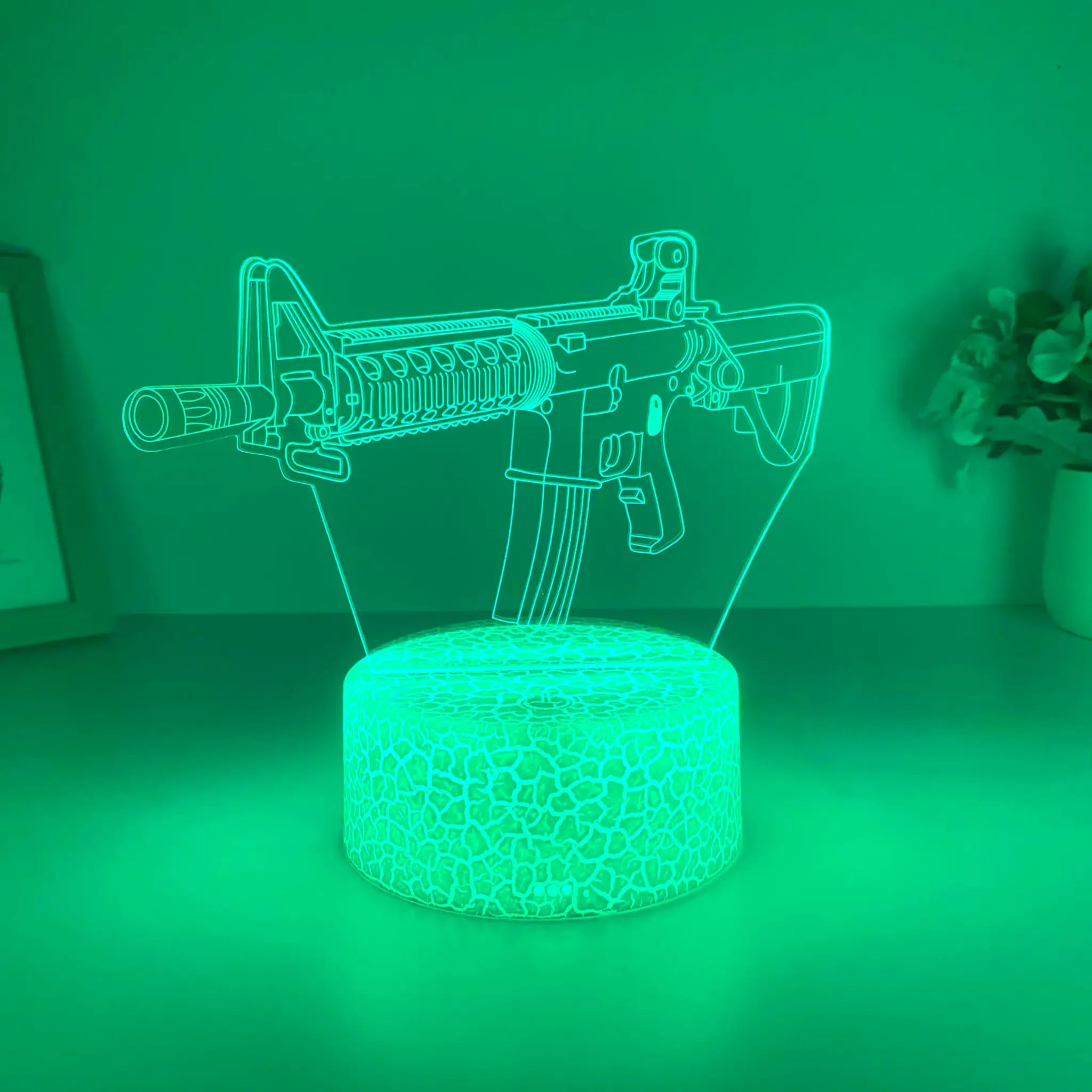 Simples Market submachine gun night light; green acrylic outline on glowing base.