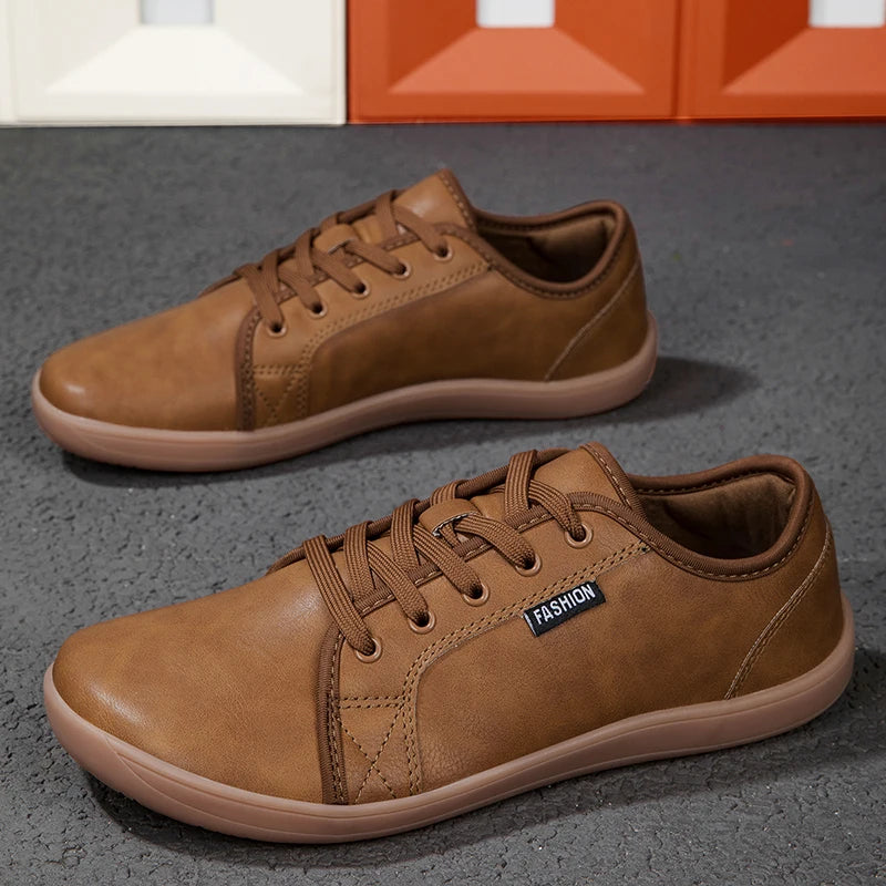 Two brown leather-style walking shoes with laces and tan soles; fashion label on the side.