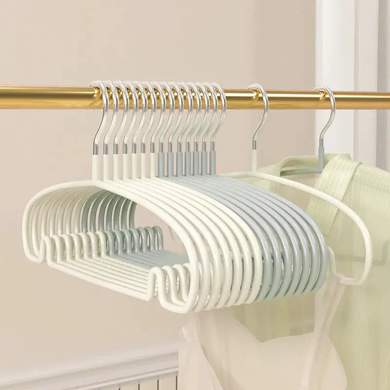 10-pack non-slip clothes hangers in white and pale blue plastic with curved shoulders for clothes protection.