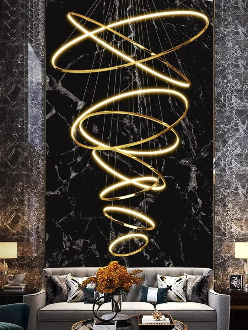Spiral pendant LED chandelier in gold, suspended over a luxurious living room