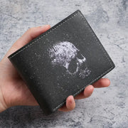 Black short wallet with white skull print and white stitched edges.