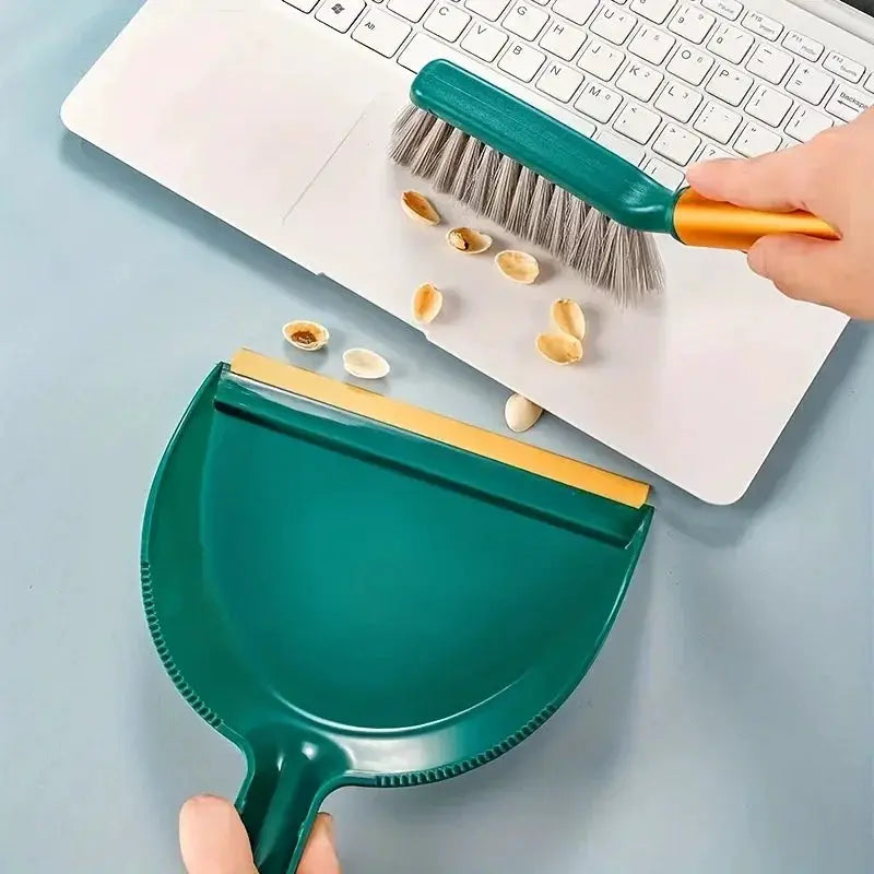 Two-piece desktop broom and dustpan set in teal with an orange handle; compact plastic cleaning tools