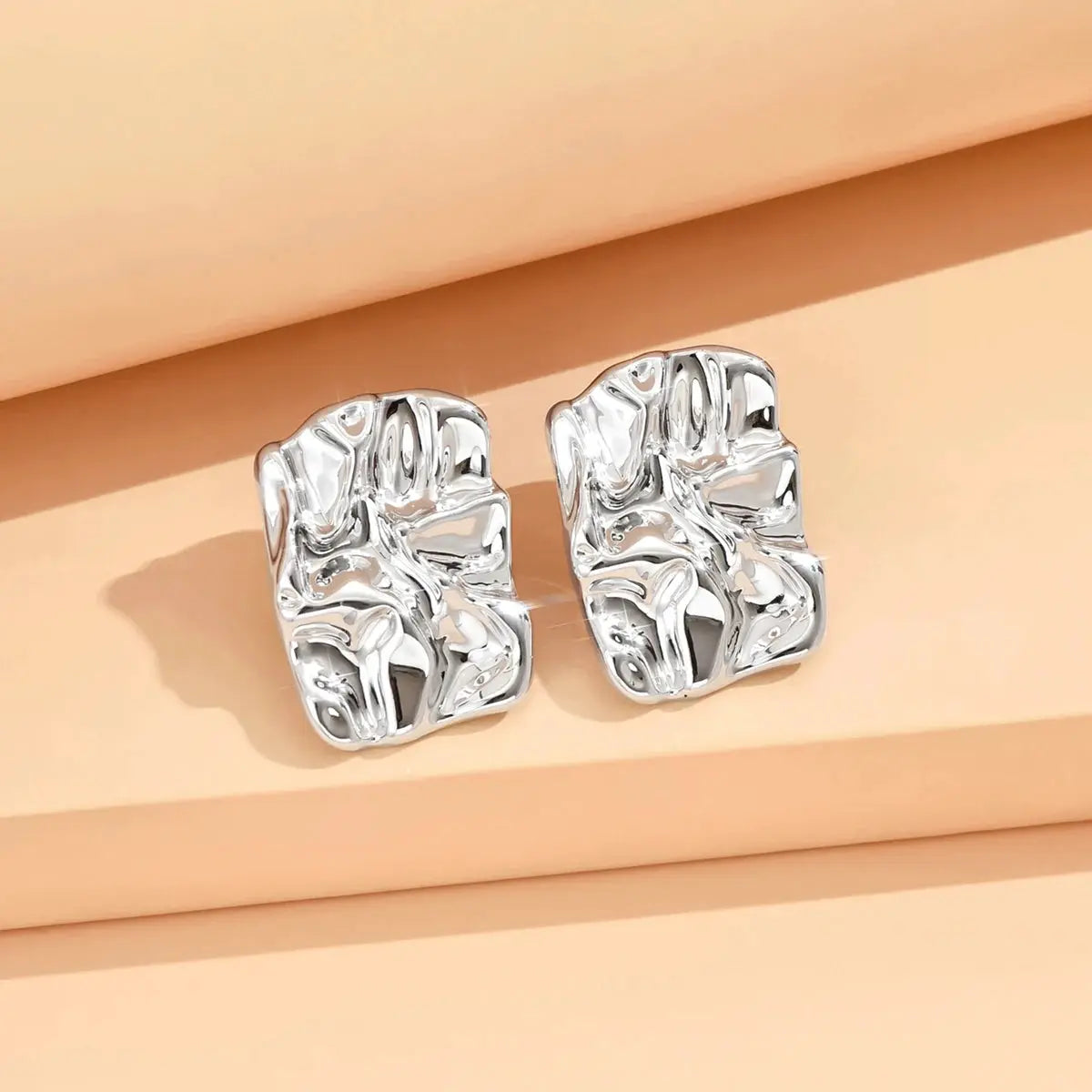 Silver geometric irregular stud earrings with a metallic finish for women