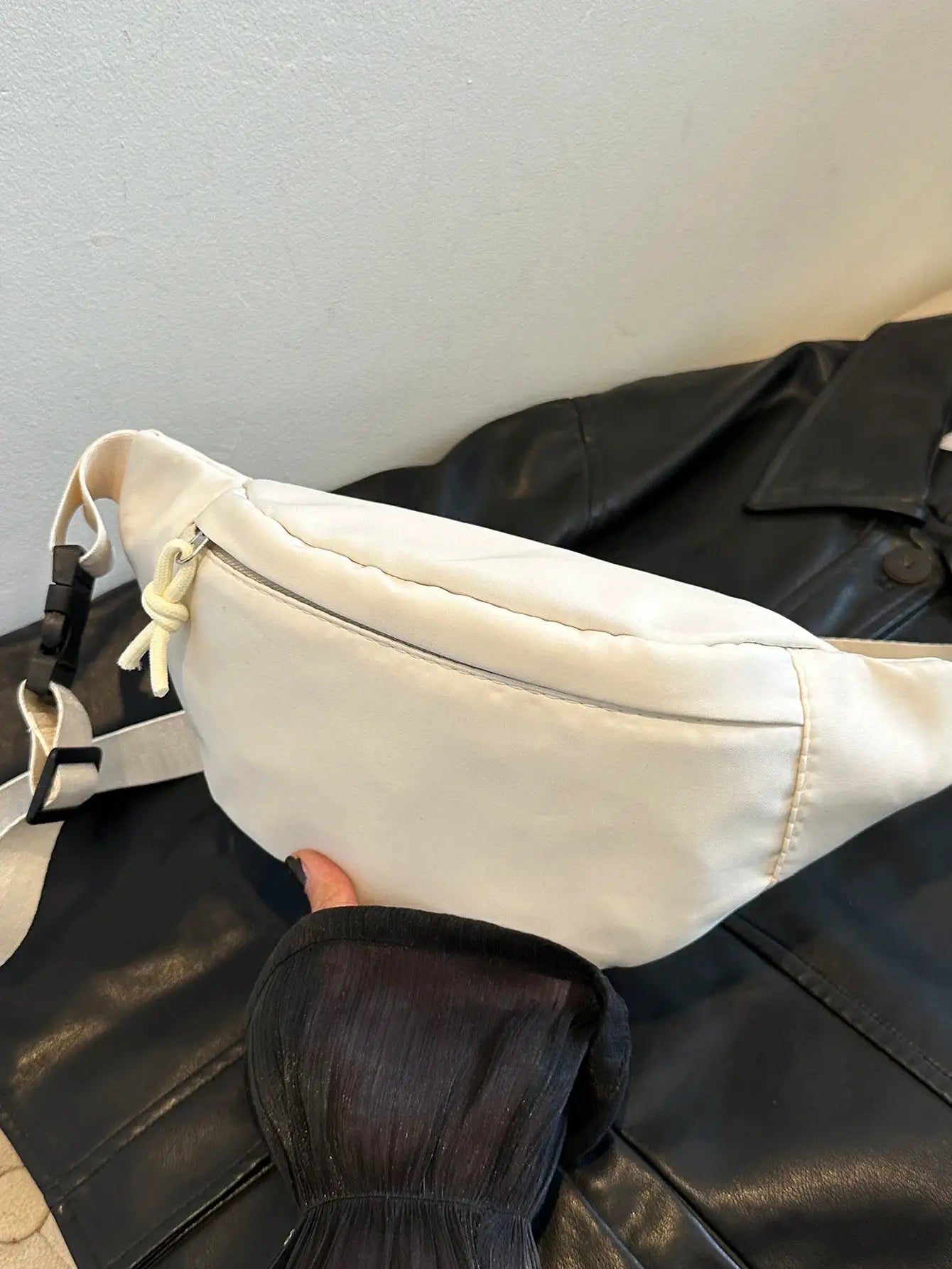 Fanny pack in white with adjustable strap, versatile for travel and workouts