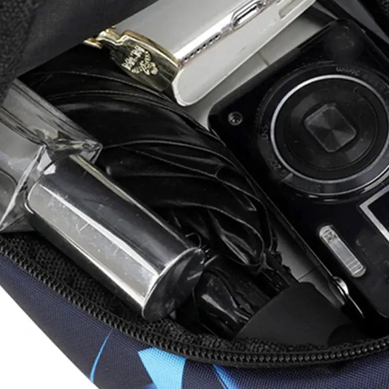 Simples Market camouflage chest bag; canvas crossbody with blue accents, opened to reveal camera gear
