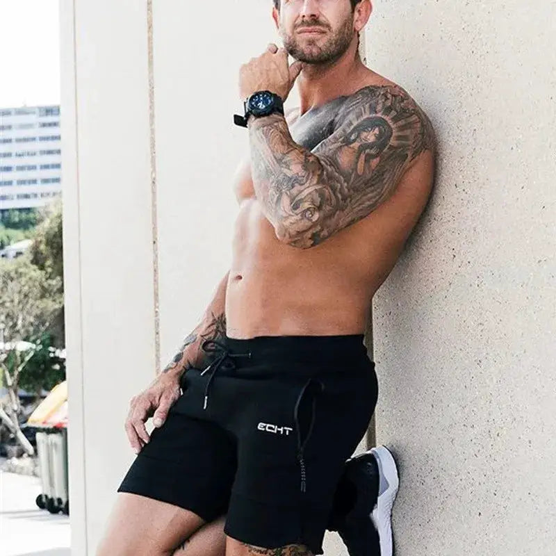 Men's black gym shorts with zip pockets and drawstring; ECHT logo
