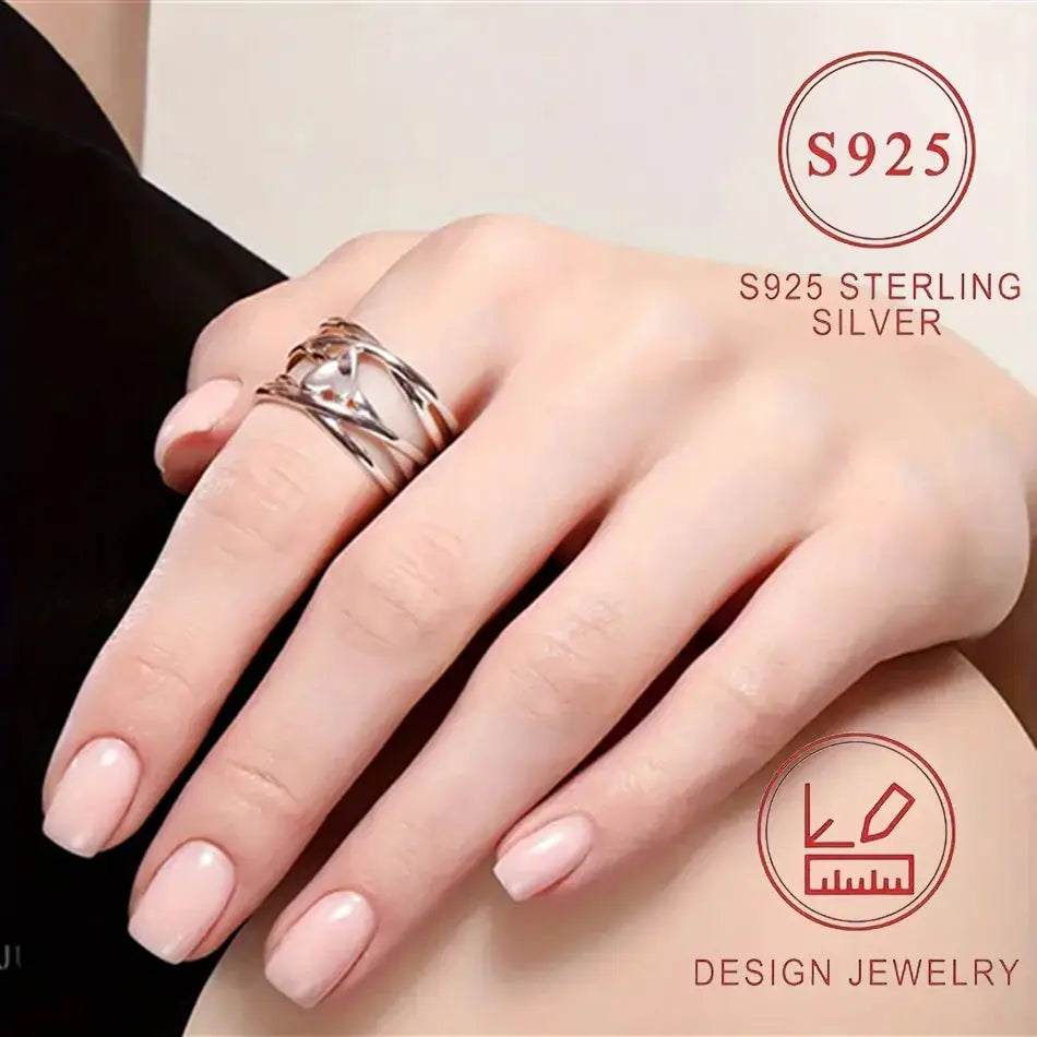 Heart-shaped 925 sterling silver ring with intertwined bands on a woman's hand