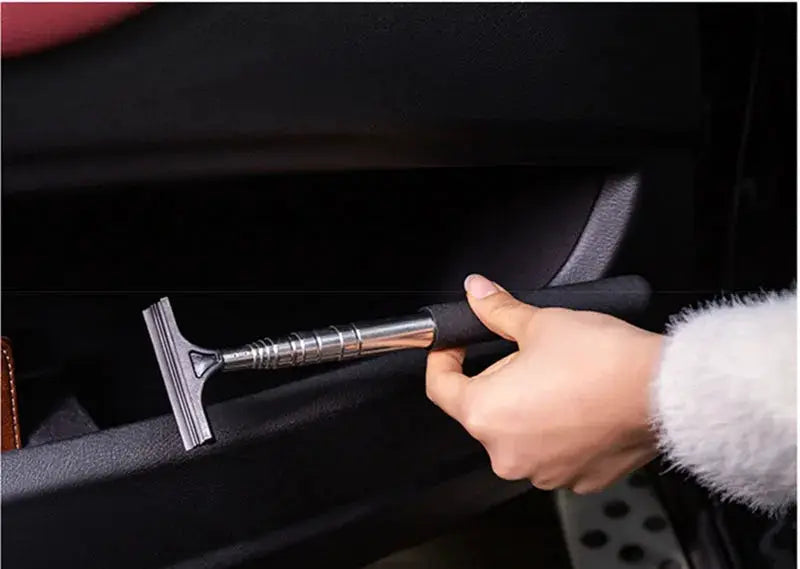 Car window cleaning tool with telescopic metal handle and foam-grip squeegee head for auto glass.