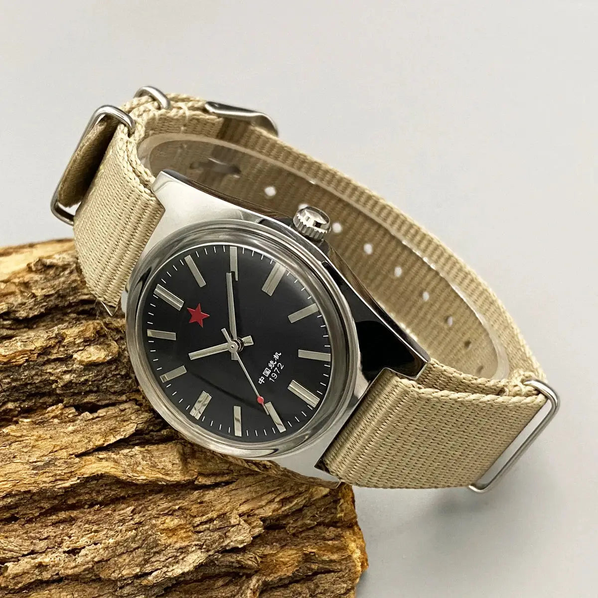 Men's 36mm mechanical watch with beige fabric strap, stainless steel case, black dial with red star.