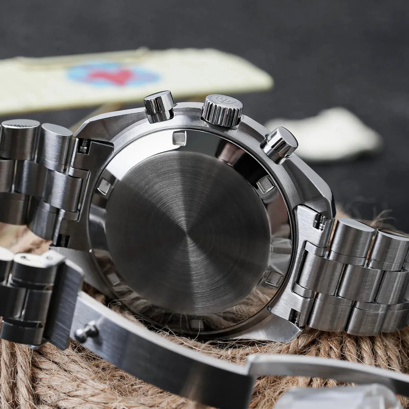 Stainless steel men's watch with brushed case back, side crown and two pushers, metal bracelet