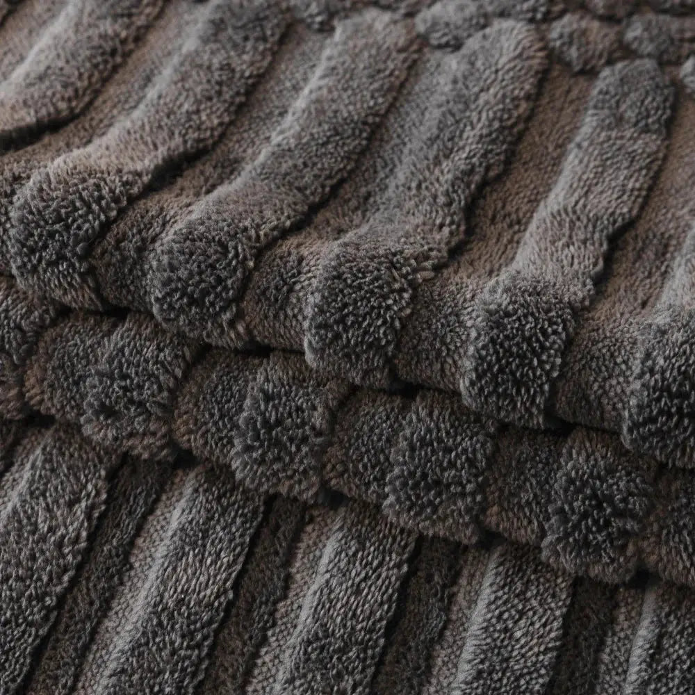 Sofa cover plush fleece in charcoal gray with thick, folded pile.