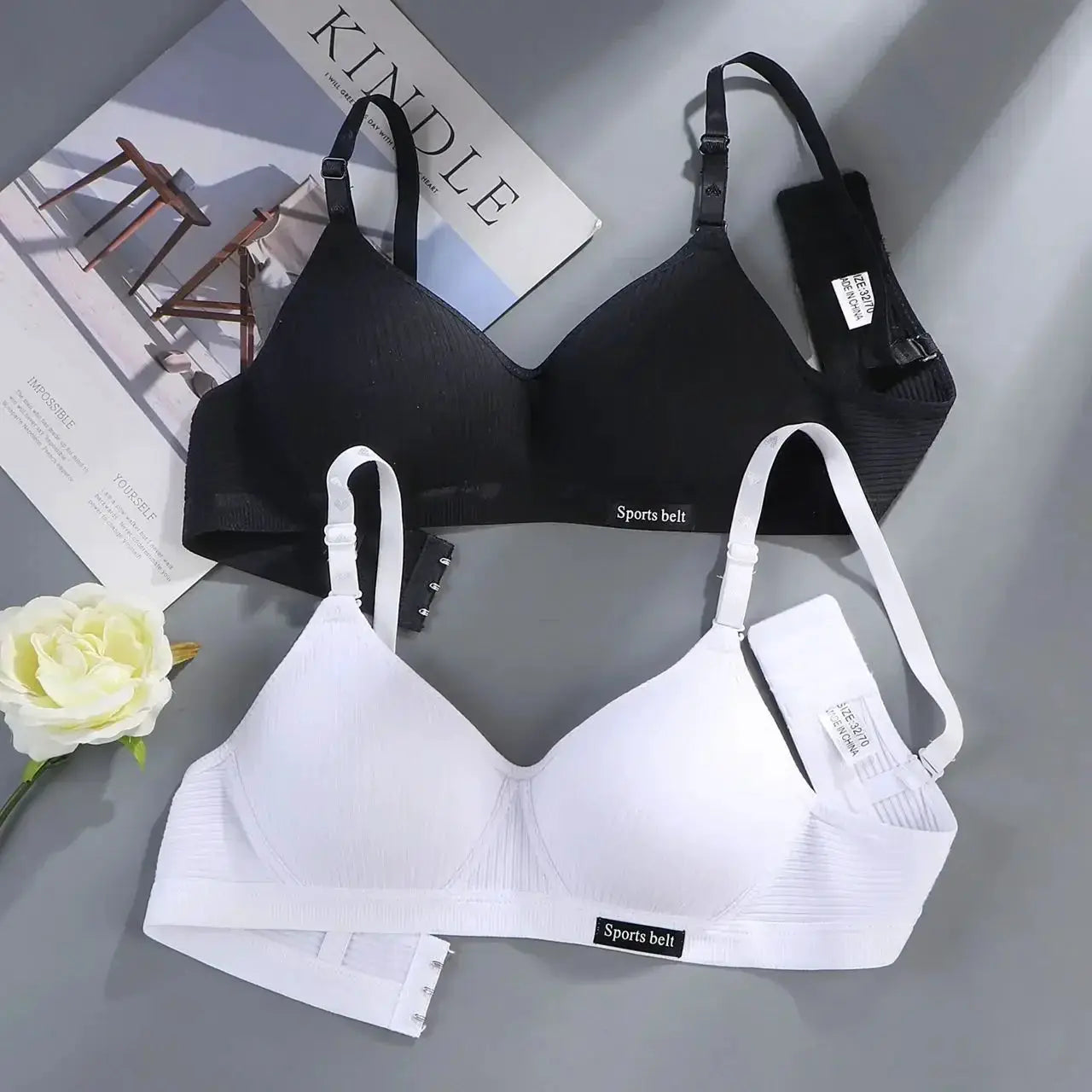 Pair of cotton wireless AB-cup bras by Simples Market in black and white with adjustable straps