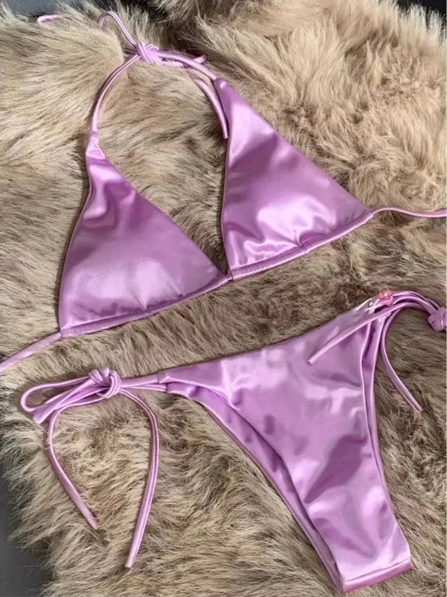 Halter bikini set in metallic pink satin; two-piece with high-cut bottoms.