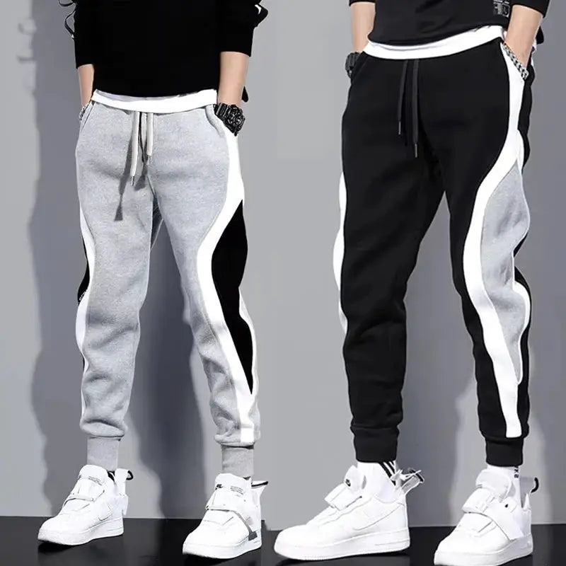 Men's patchwork joggers by Simples Market, grey with white and black color-block panels, drawstring waist, cuffed ankles