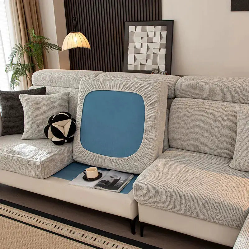 Thick plush sofa cushion cover with elastic fit and blue inset cushion on a light gray sectional.
