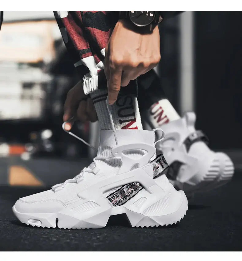 Pair of men's white high-top athletic sneakers with breathable knit, chunky sole and strap detail