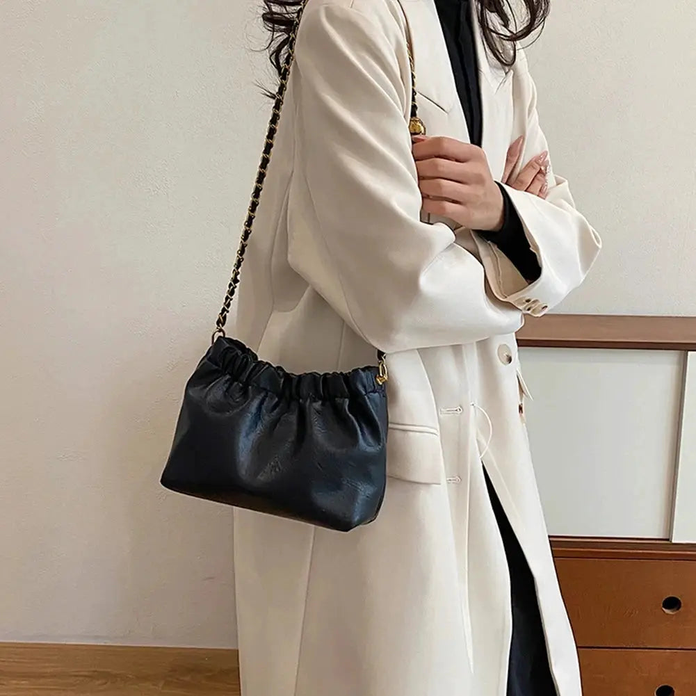 Chain-strap crossbody bag in black with gathered top, faux leather