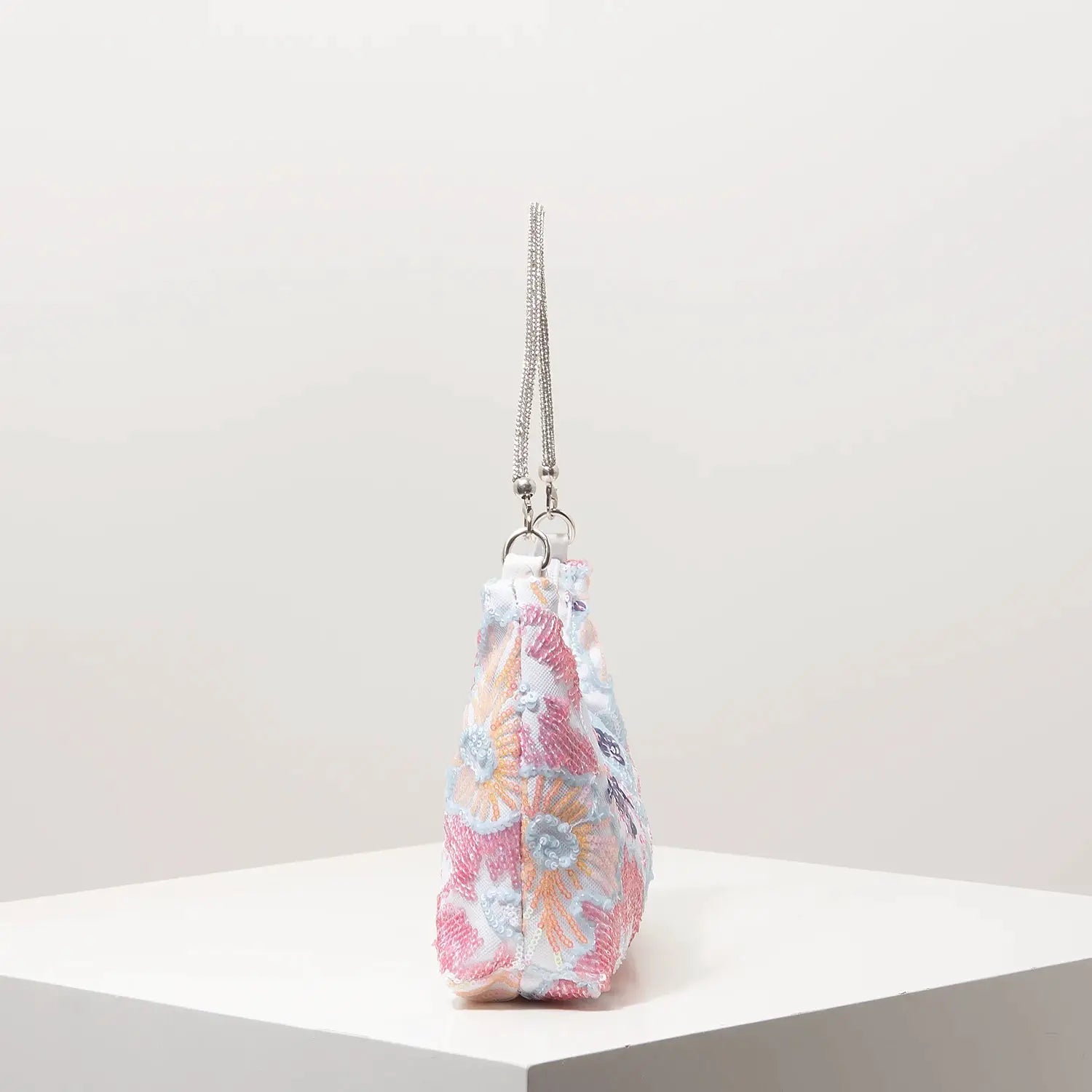 Shoulder bag with pastel floral embroidery and sequin accents on a silver chain strap
