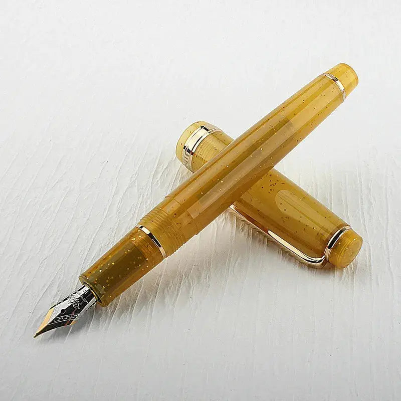 Jinhao 82 fountain pen in amber acrylic with gold trim and exposed nib