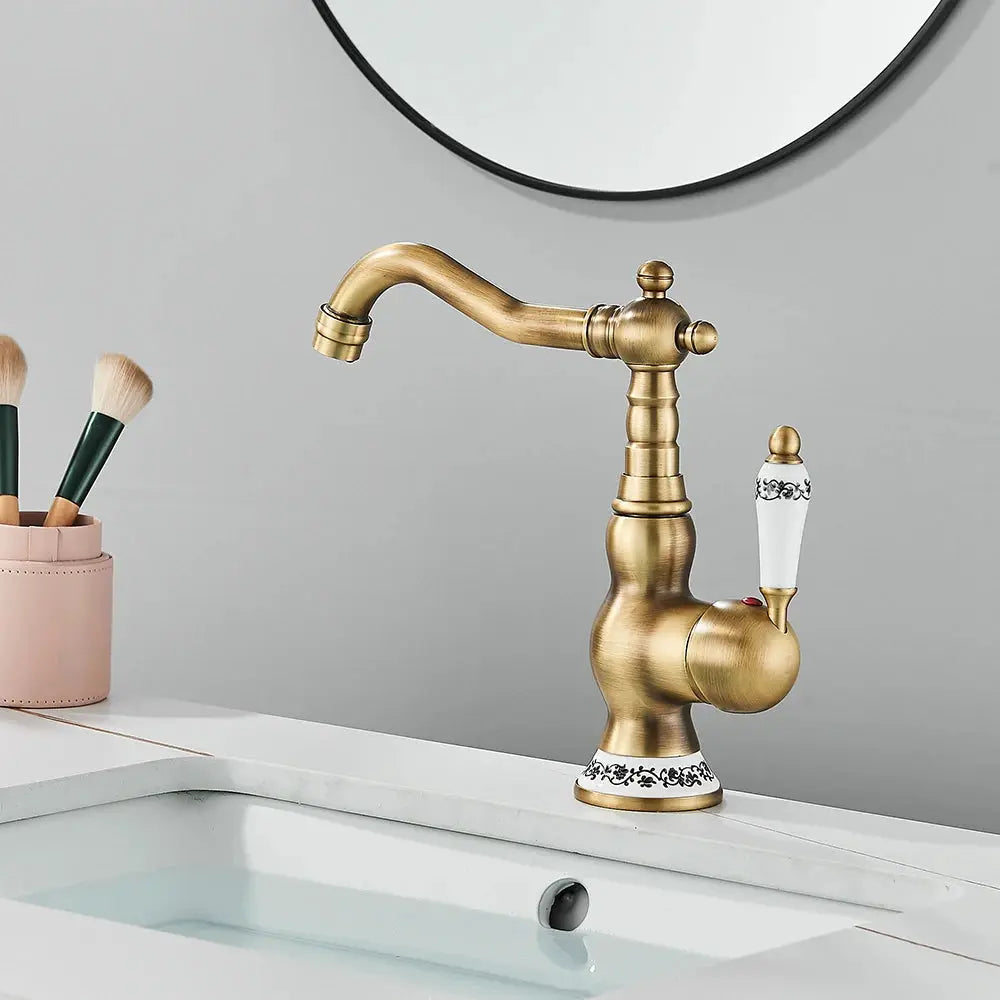 Antique brass bathroom faucet with rotating spout and white porcelain lever, Simples Market