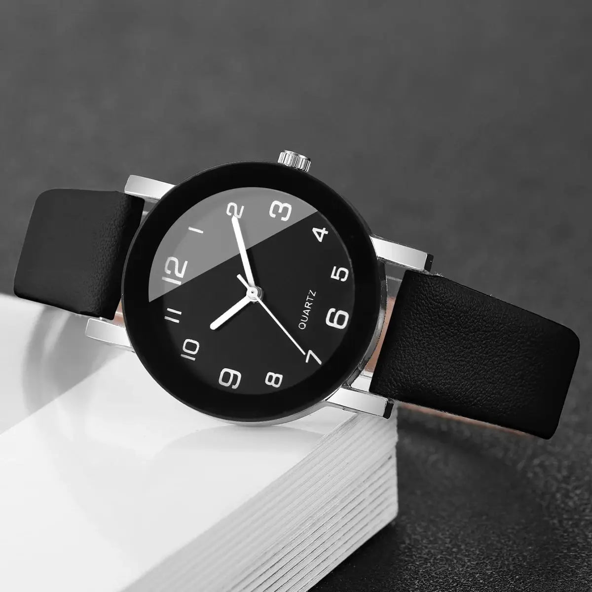 Wristwatch with black leather strap, silver case and Arabic dial, quartz movement