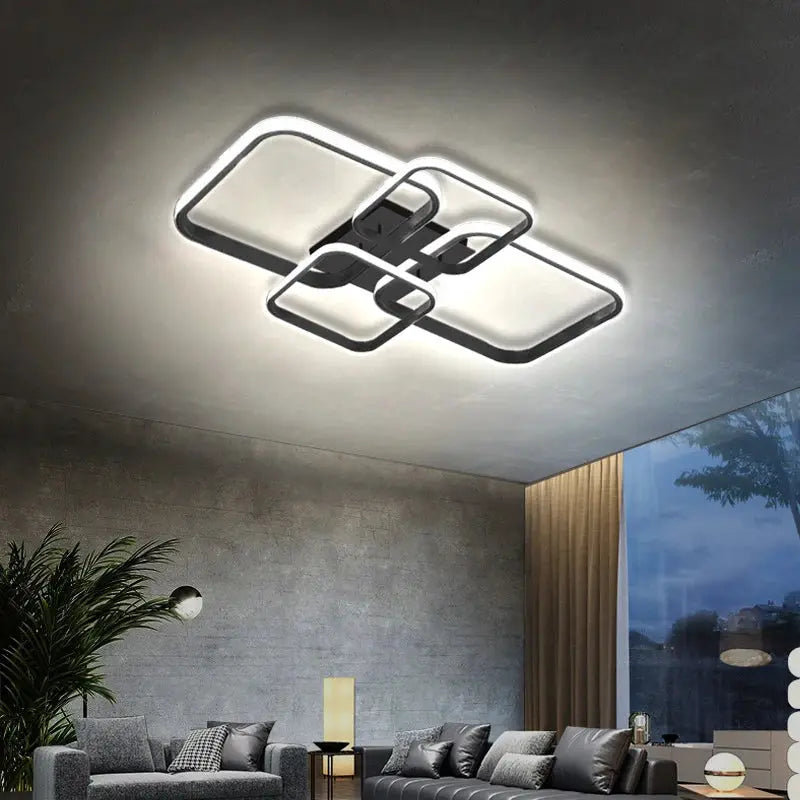 Modern LED ceiling light with four square heads in black and white finish.