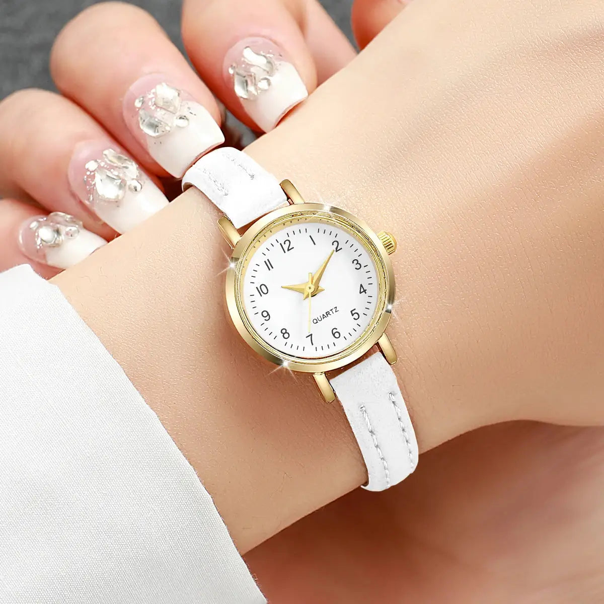 Women's quartz watch with white dial, gold-tone case and white leather strap