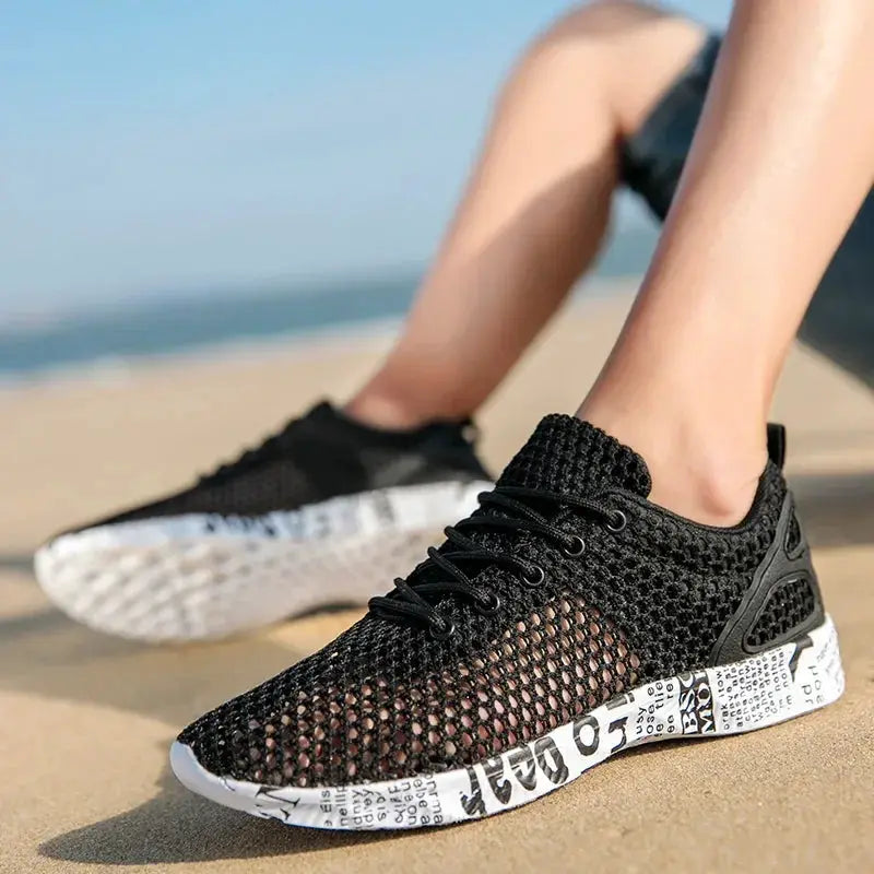 Men's black air-mesh sneakers with white newspaper-printed foam sole for beach and water activities