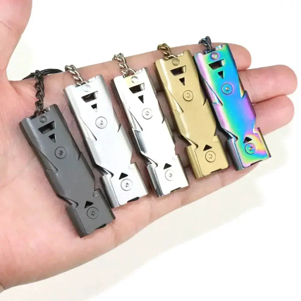 Double pipe whistle pendant keychains, six in assorted colors including gray, silver, gold, and rainbow iridescent.