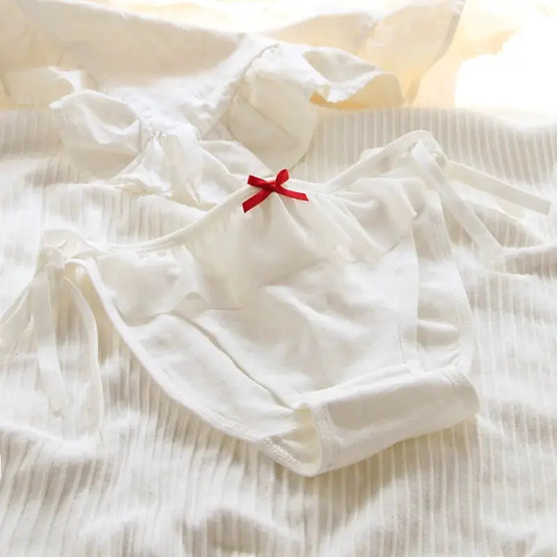 White low-waist briefs with side ribbons and a red bow, women's underwear