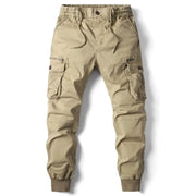 Men's khaki cotton cargo pants with multiple pockets, drawstring waist, and ribbed ankle cuffs
