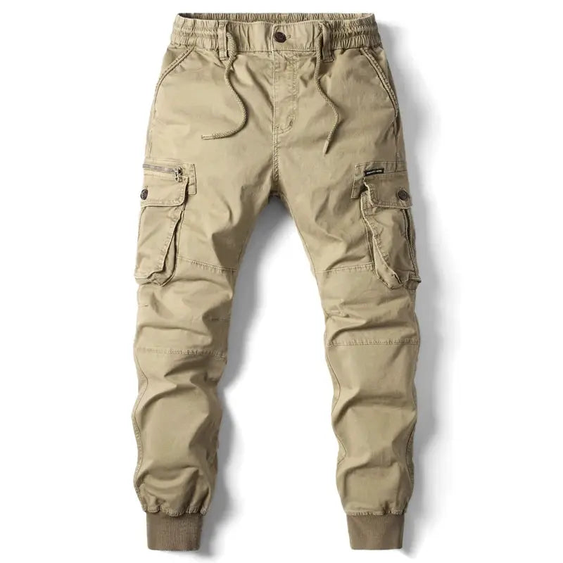 Men's khaki cotton cargo pants with multiple pockets, drawstring waist, and ribbed ankle cuffs