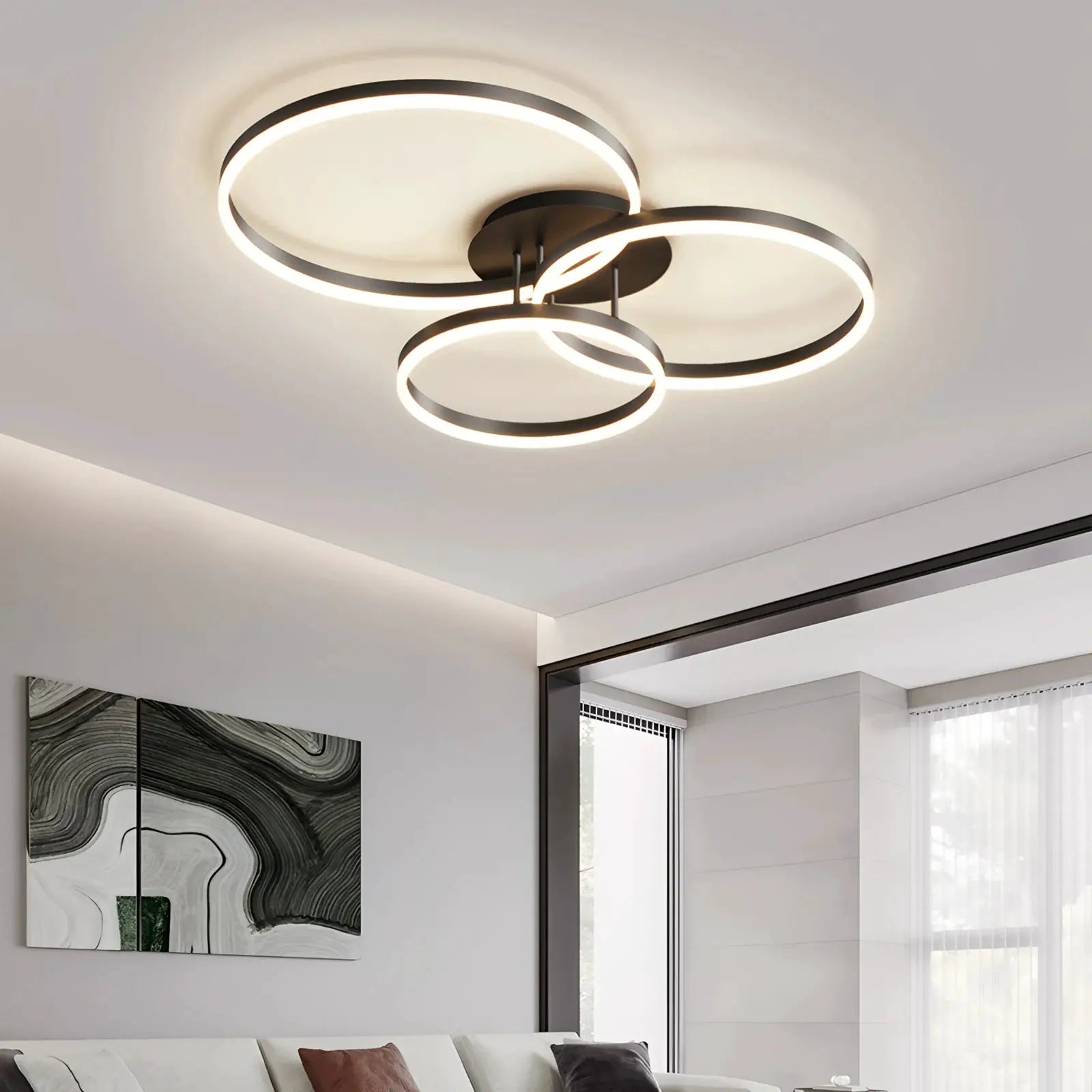 Smart ceiling chandelier with three glowing circular rings in black metal finish for living room