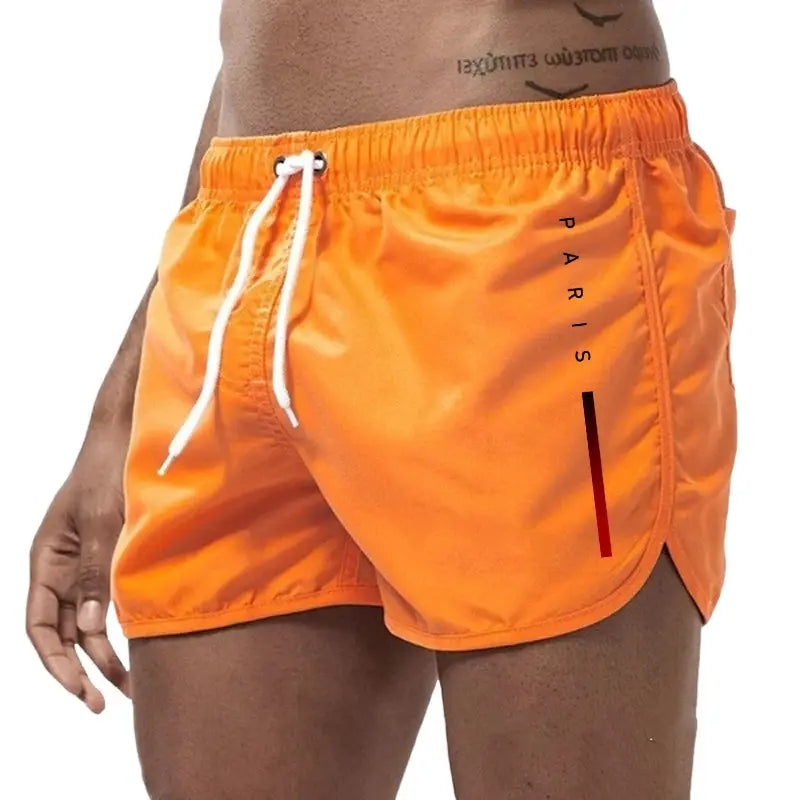 Men's orange board shorts with white drawstring and Paris vertical print, beach-ready athletic shorts