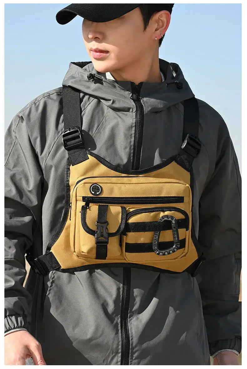 Outdoor tactical chest bag by Simples Market; tan utility EDC chest pack with multiple pockets and black straps.