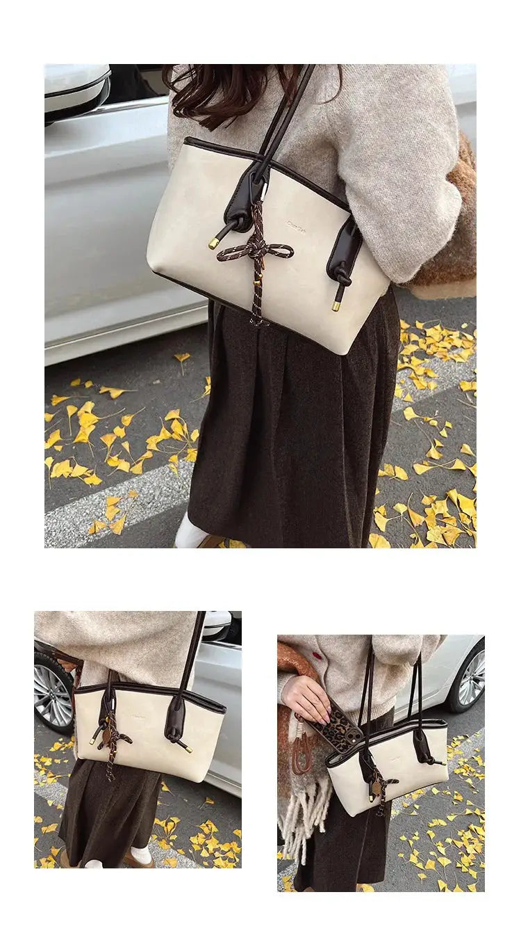 Simples Market PU leather shoulder bag in beige with dark brown trim and tassel bow charm.