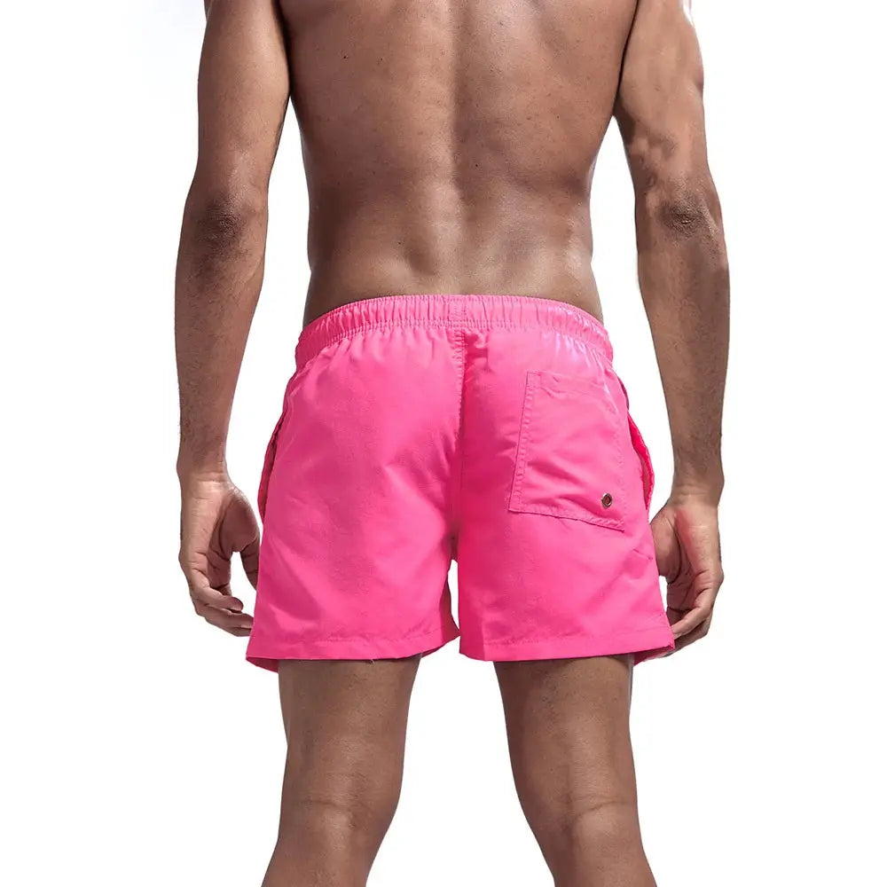 Men's pink quick-dry swim shorts with elastic waistband and back pocket