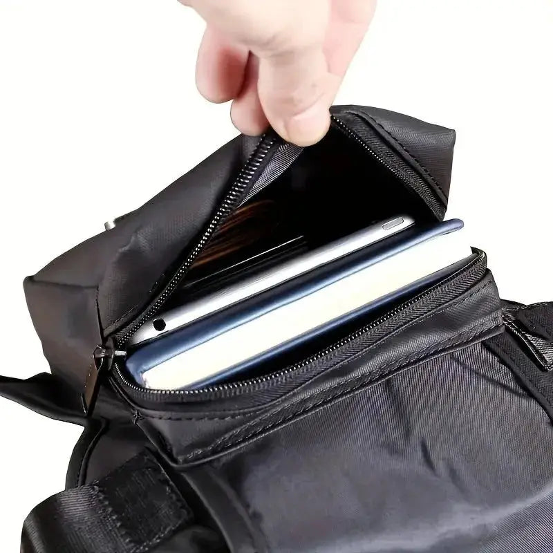 Leg bag by Simples Market, black, opened to show two devices (phone and tablet) in zippered chambers