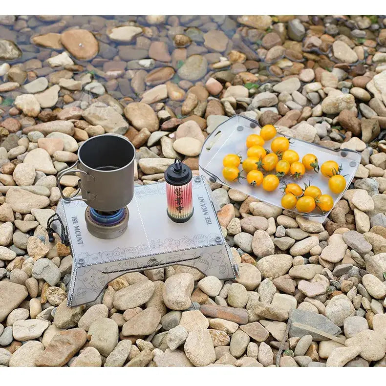 TINSOL Ultralight folding mini table, gray PP camping table with a tomato tray on rocky shore