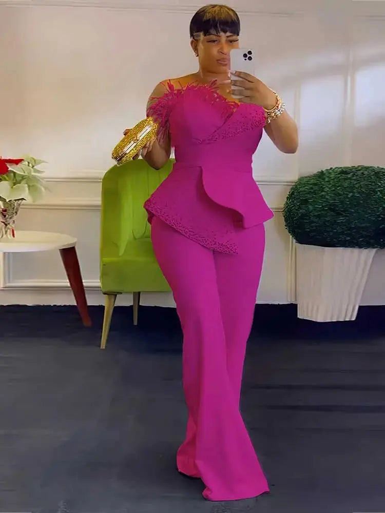 High waist strapless magenta jumpsuit with peplum detail and wide legs