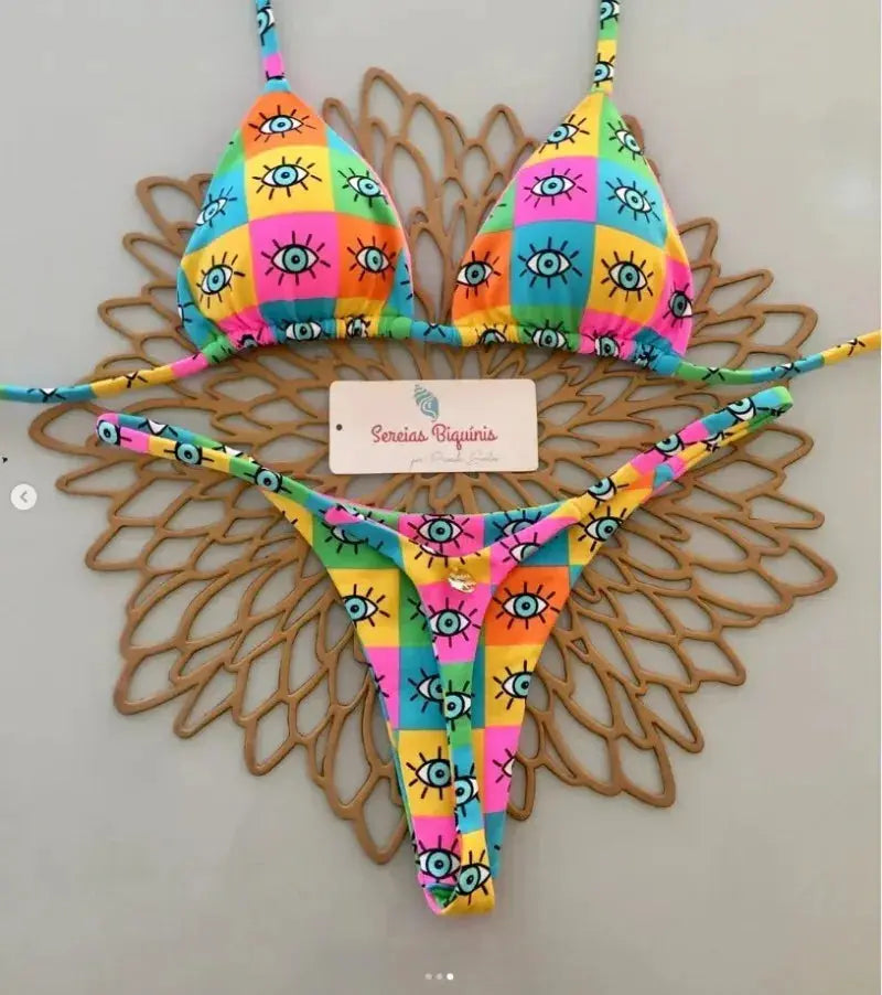 Simples Market women's bikini set with halter top and thong bottom in bright multicolor eye-print patchwork.